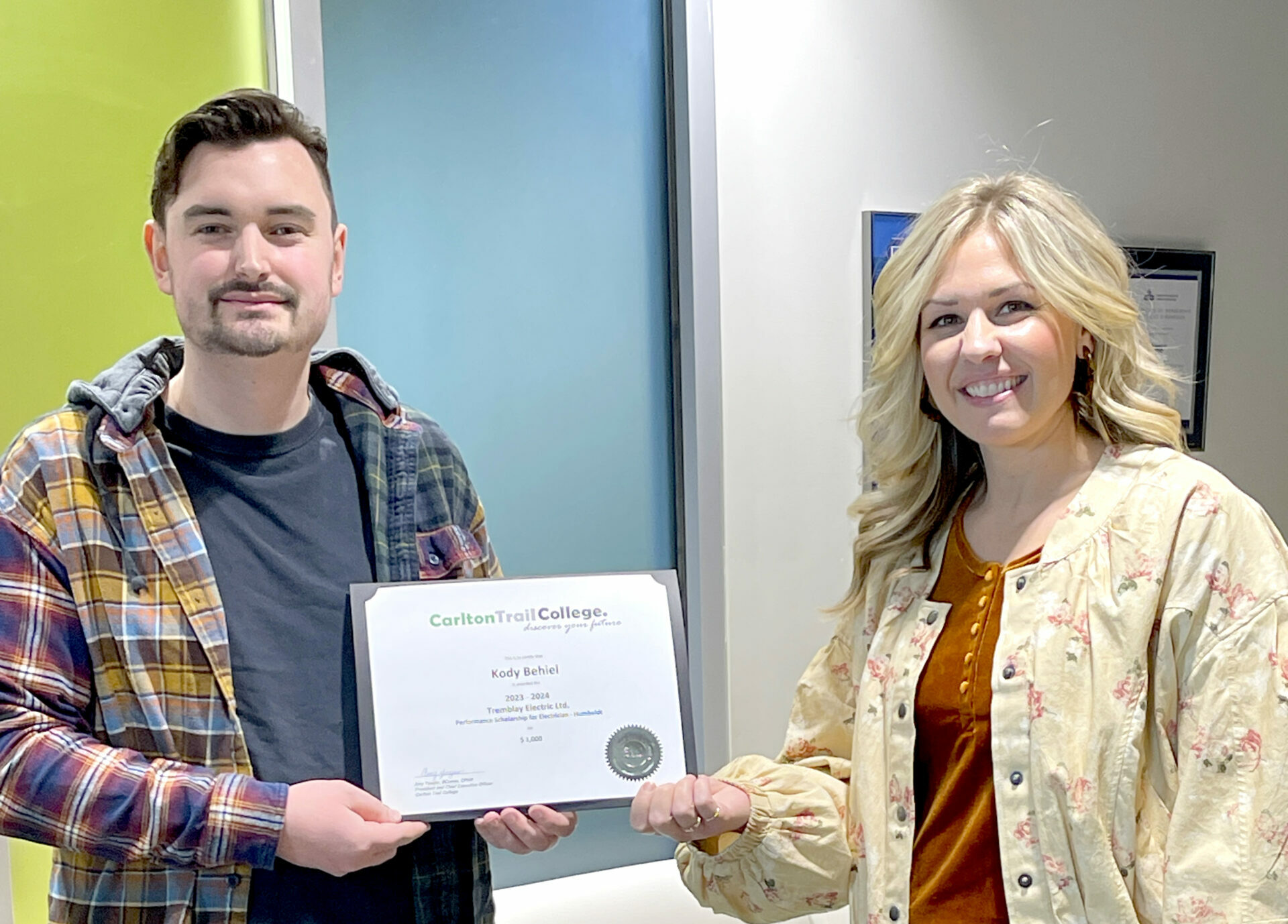 Stacey Tremblay presents Electician student, Kody Behiel, with a Performance Scholarship for $1000 sponsored by Tremblay Electric